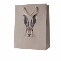 Geschenktragetasche mit Osterhasen-Motiv aus naturbraunem Strukturpapier mit Spot-UV-Akzent und Baumwollkordel.