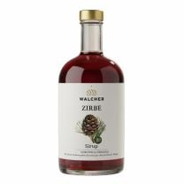 Walcher Zirbensirup BIO in eleganter Glasflasche mit feiner Zirbenoptik und goldfarbenem Verschluss.