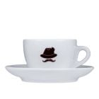 Kuntrawant Schmuggler-Cappuccino Tasse, markantes Schnäuzer-Emblem, als Symbol für die historische Kaffee-Schmuggeltradition in Südtirol. 
